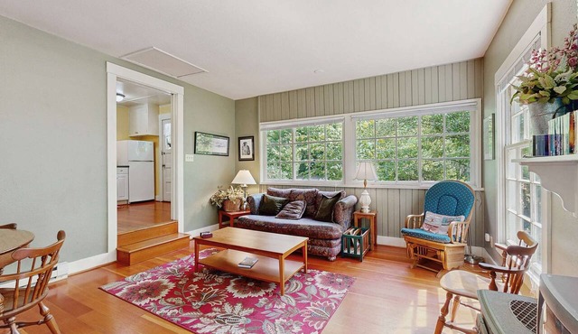 Tranquil landscape with riverside firepit, gas grill, gas fireplace, and deck in Molalla